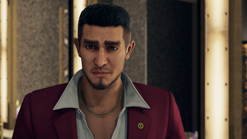 Nachdenklicher Ichiban Kasuga aus Yakuza: Like a Dragon, ein emotionaler Moment, der die menschliche Tiefe des Spiels zeigt.