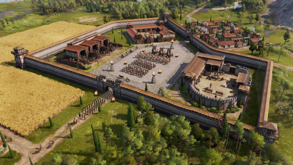 Römisches Militärlager mit Mauern, Türmen, Exerzierplatz und umliegenden Feldern – detailreiche Szene aus Anno 117: Pax Romana, dem neuen Strategiespiel von Ubisoft Mainz.