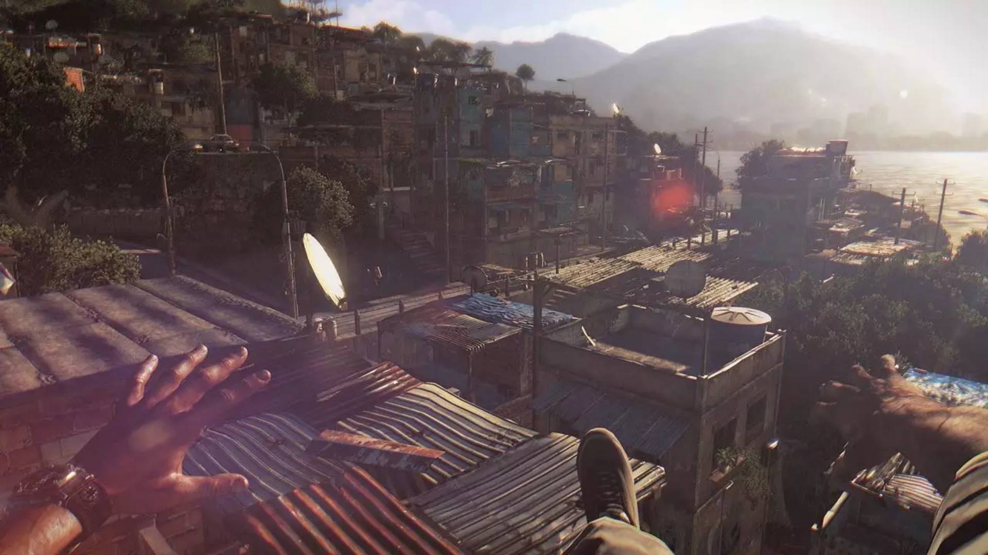 Blick über die Dächer einer dicht bebauten Stadt in Dying Light aus der Ego-Perspektive