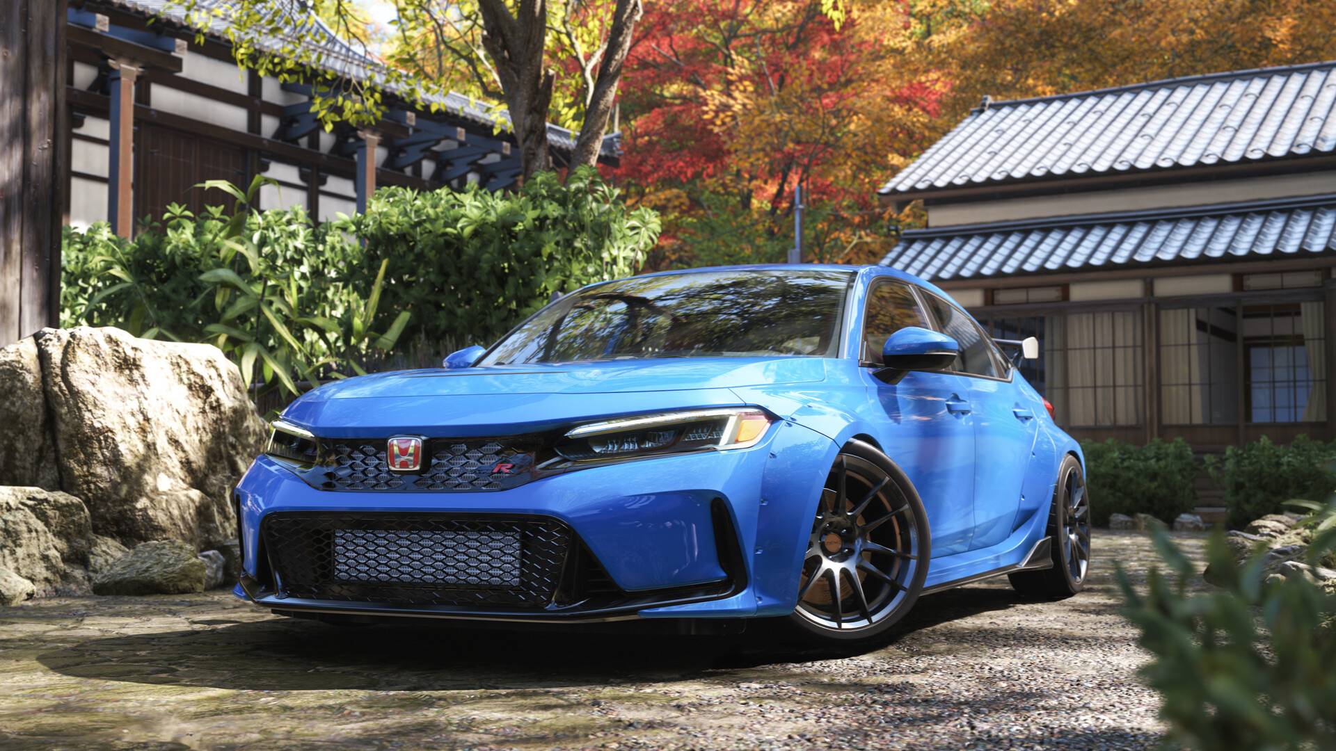 Ein sportlicher blauer Wagen in Forza Horizon 6 steht vor traditionellen japanischen Häusern, umgeben von herbstlicher Vegetation.