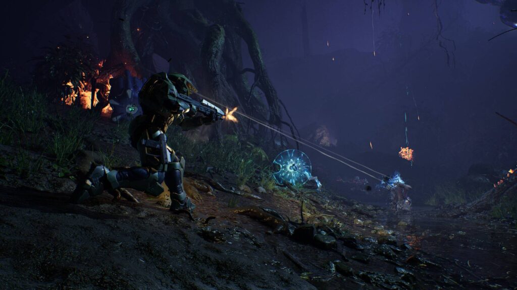 Master Chief kämpft in Halo: Campaign Evolved aus der Third-Person-Perspektive gegen Covenant-Gegner in einem dunklen Dschungel.