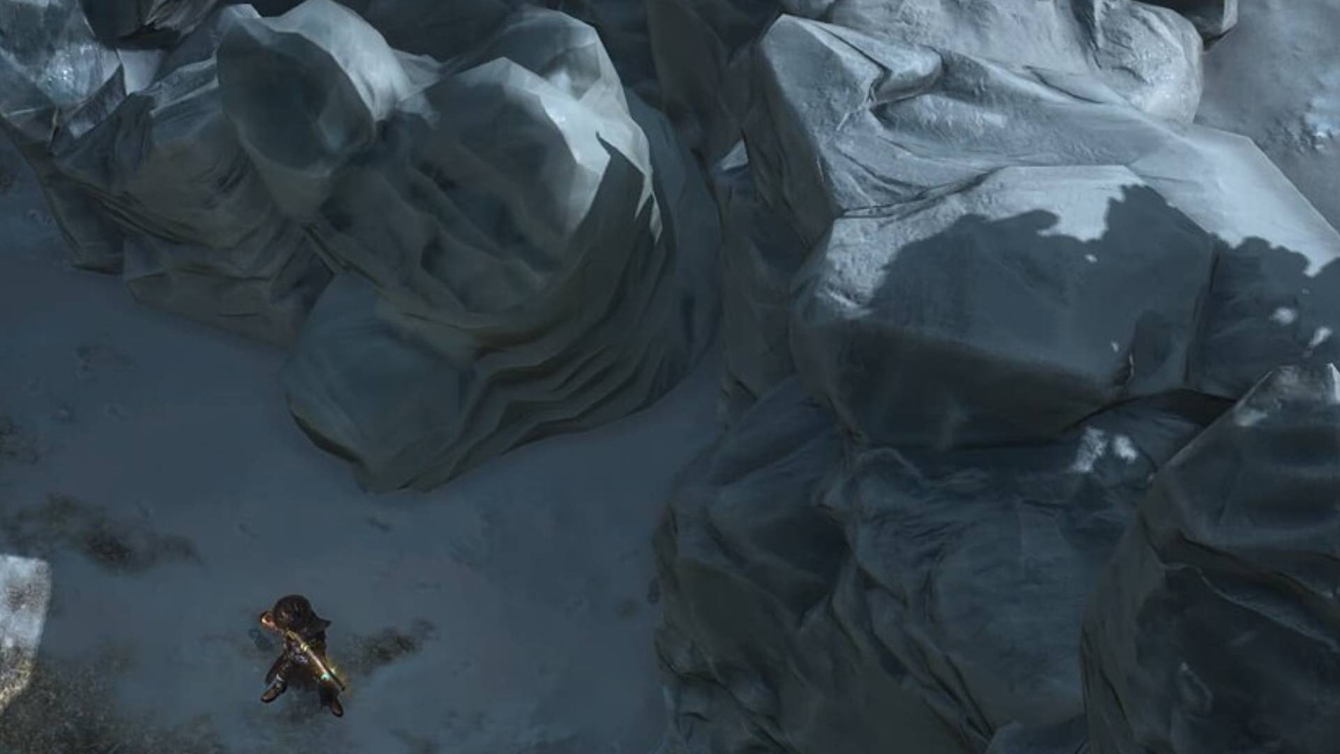 Grim Dawn zeigt eine kleine Figur in einer eisigen Felslandschaft vor riesigen grauen Felsformationen und Schnee.