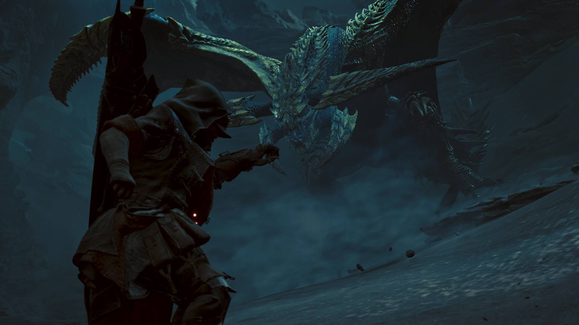 Ein Jäger stellt sich in Monster Hunter Wilds einem gewaltigen geflügelten Drachen in einer dunklen Höhle.