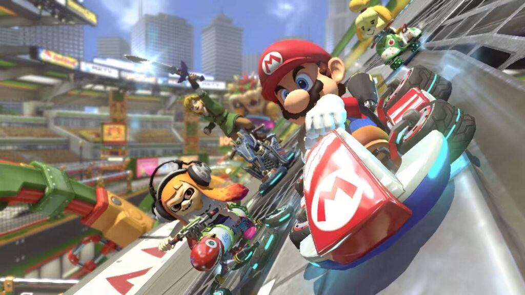 Mario Kart 8 Mario fährt mit Link und einem Inkling über eine steile Rennstrecke
