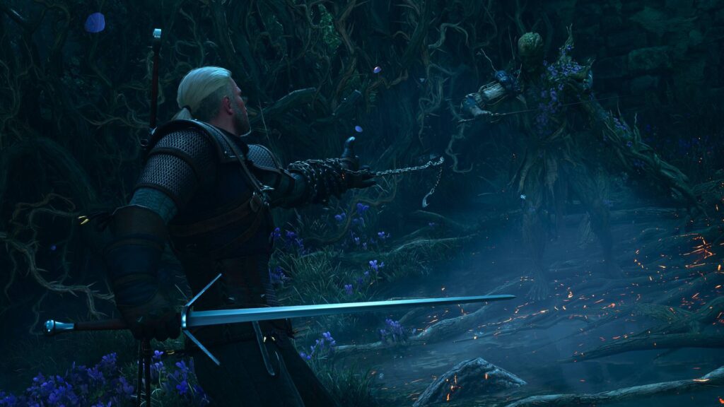 Songs of the Past Geralt kämpft mit Schwert und Kette gegen eine Kreatur in einem düsteren Wald