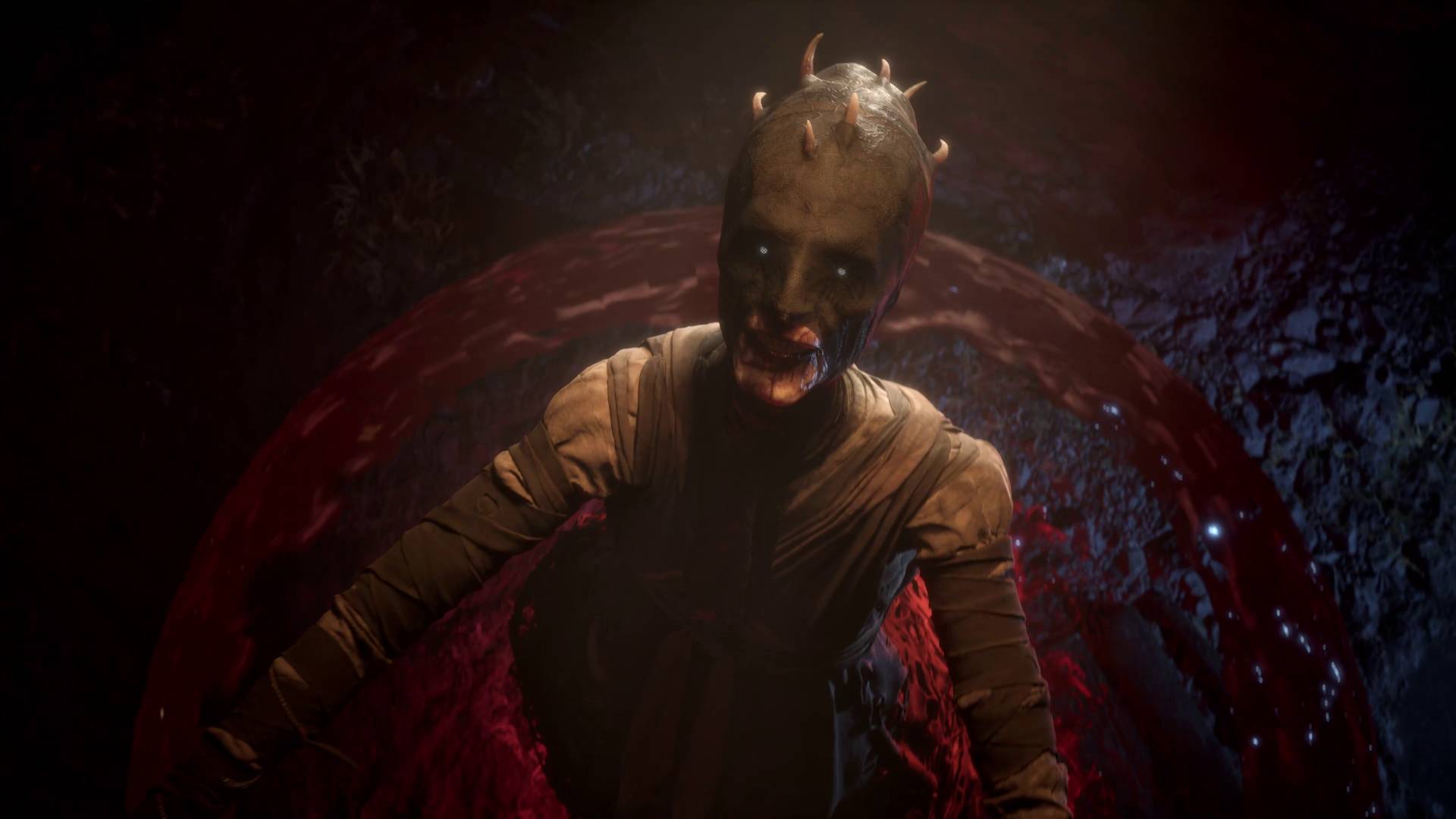 The Blood of Dawnwalker: Xanthe vor blutroter Kulisse in einer dunklen Höhle