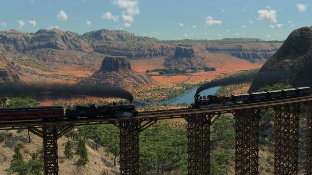 Transport Fever 3 zwei Züge auf einer Brücke durch eine Berglandschaft